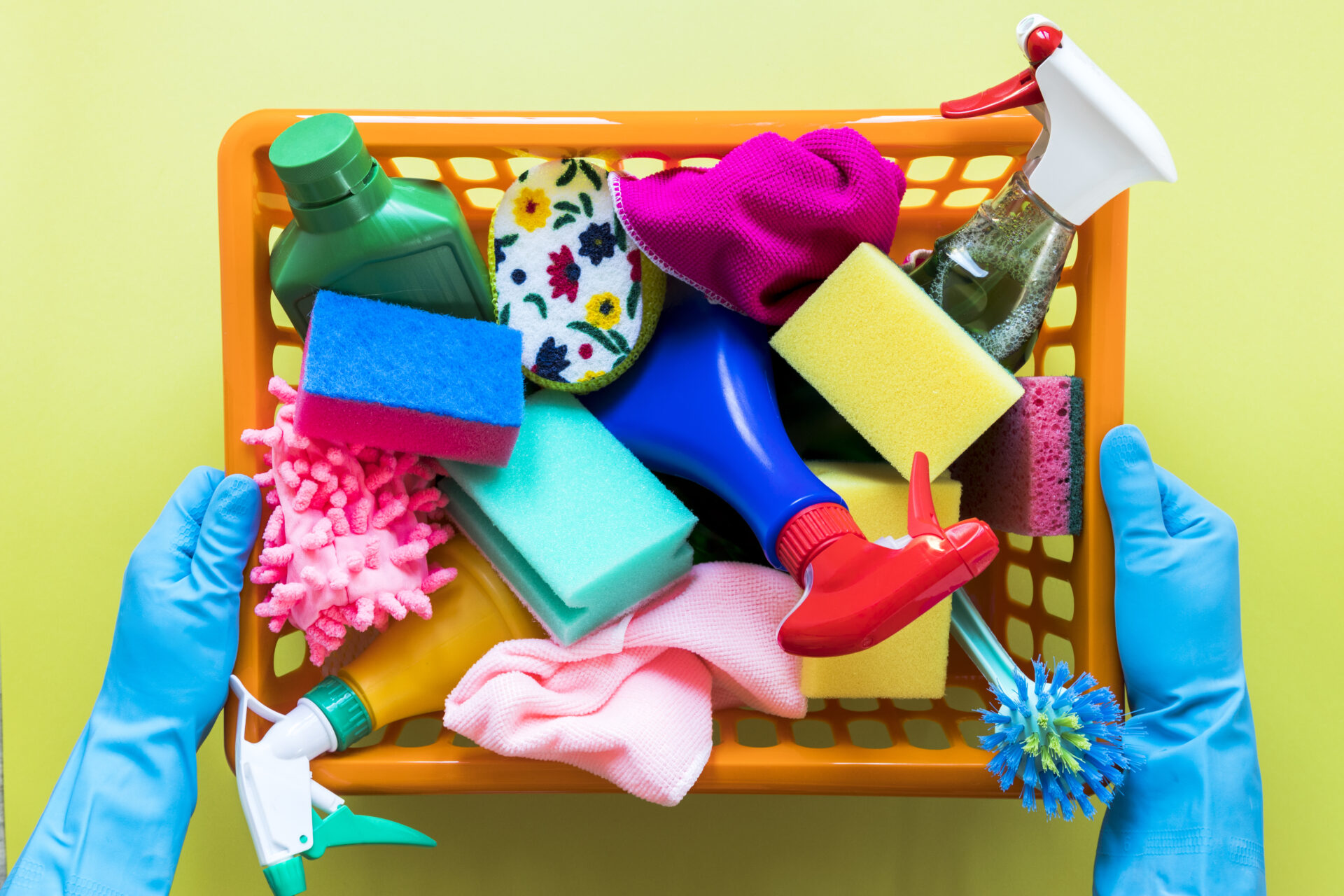 A Basket of Sponges and Cleaning Sprays